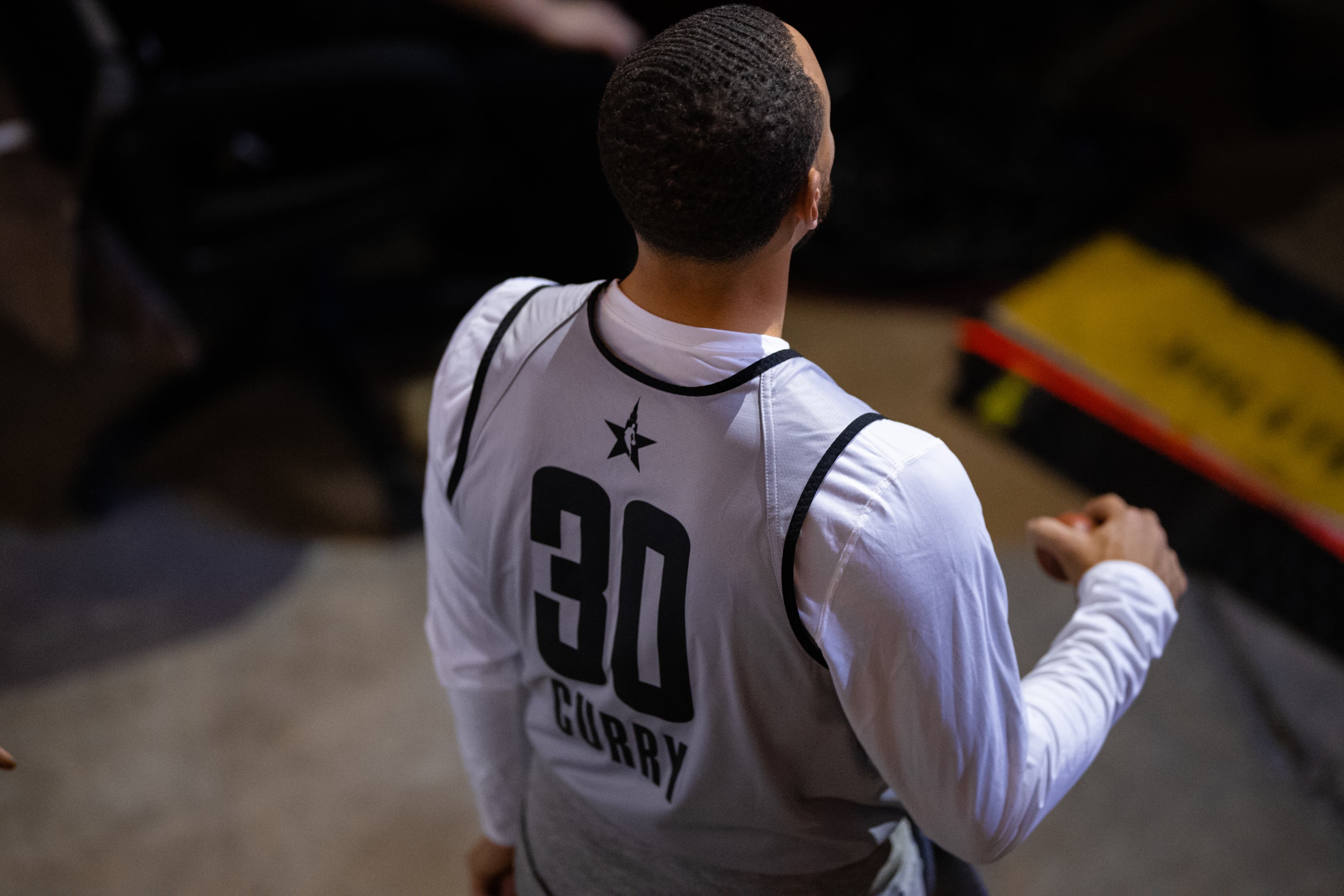 Stephen Curry in action during an NBA game, wearing his Golden State Warriors uniform
