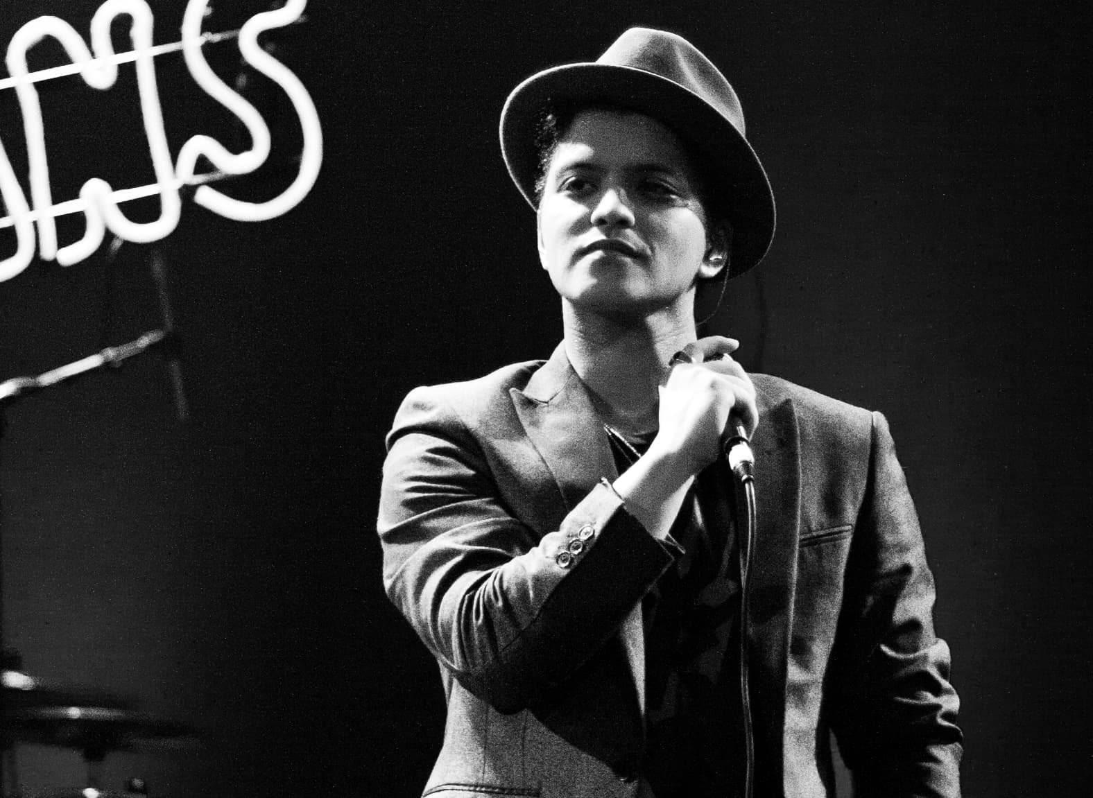 Bruno Mars in a black-and-white performance photo.